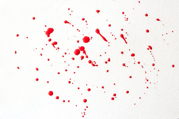 drops of red paint on a white background