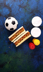 Grilled hot dogs with mustard and ketchup on the table with draft beer for football soccer party...