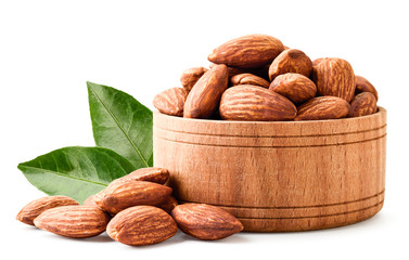 Almond in a wooden plate close-up on a white. Isolated