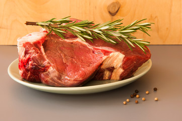 Raw beef fillet steaks with herbs and spices