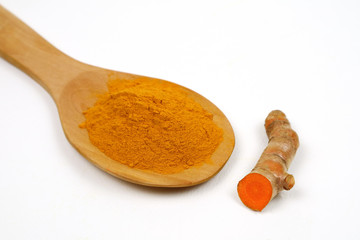 Turmeric powder (curcuma) and turmeric roots isolated on a white background Is an ingredient in...