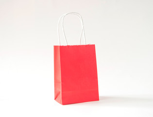 colorful paper bags with handles on a white background