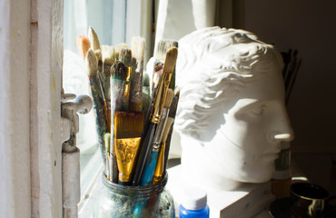 Workplace painter palette with colors and brushes. Palette of colors, creative disorder, art.