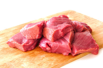Raw pork fillet on a cutting board on a white background