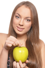 Portrait of beautiful young woman with green apple