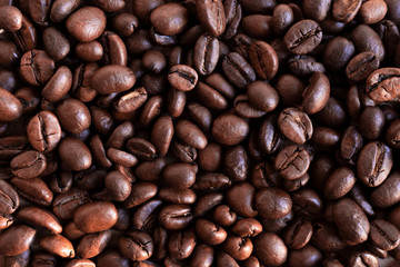 Coffee beans background. Large arabica beans on the table. 