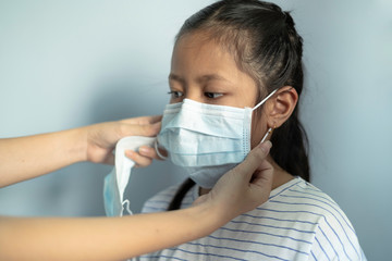 Children girl waring mask to protect Covid-19 virus and PM2.5 air pollution