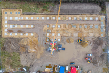 Drone image of a large construction site on which the concrete foundation for the columns of a factory building is being cast