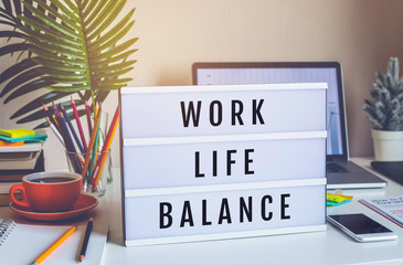 Work Life Balance concepts with text on light box on desk table in home office.positive emotion to...