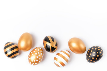 Easter background or easter concept. Easter golden decorated eggs isolated on white background. Minimal easter concept. Easter card with copy space for text. Flat Lay of Golden Easter Eggs.