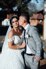 Fototapeta premium Bride and groom kisses tenderly. Beautiful pictures. Guys enjoy. Sexy kissing stylish couple of lovers close up portrait 