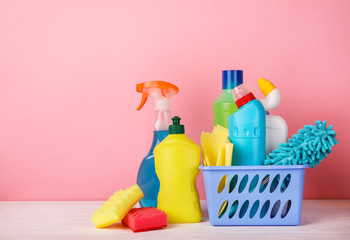 Set of cleaning products on pink background