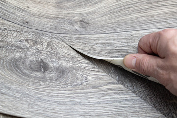 Roll of linoleum with a wood texture. Linoleum cutting. Floor coverings.