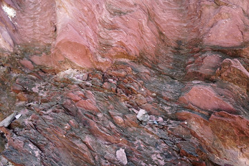 texture of shale stone in the nature. Red shale sedimentary rocks formed of thick layers of clay minerals in a calm water setting. Shale can come in many colors.