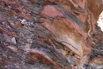 texture of shale stone in the nature. Red shale sedimentary rocks formed of thick layers of clay minerals in a calm water setting. Shale can come in many colors.