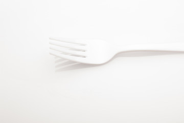 Plastic fork for casual food. White fork.