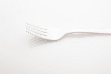 Plastic fork for casual food. White fork.