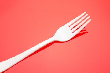 Plastic fork for casual food. White fork.