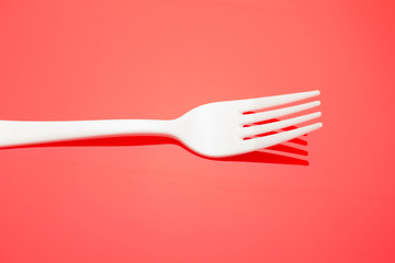 Plastic fork for casual food. White fork.