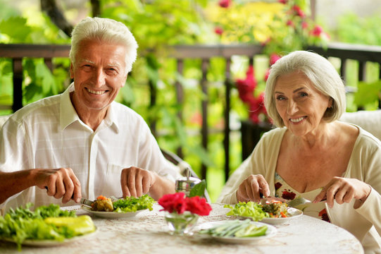 Close up portrait of happy senior couple having diner