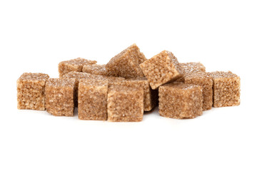 Cane sugar on a white background. Cane sugar cubes close up.