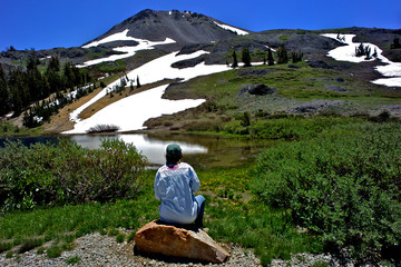 Women sitting on boulder viewing Highland Lake and Hiram Peak, Sierra Nevada Mountains, California 