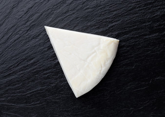 Cheese on a slate surface. Piece of cheese close-up.