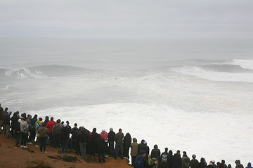 People looking at the tow surf challenge, Nazarè, Portugal