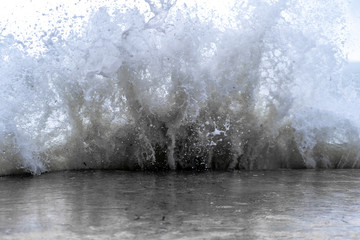 huge wave strikes the shore