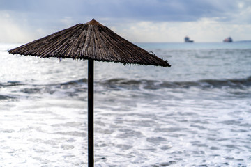 sun umbrela in stormy weather near the sea