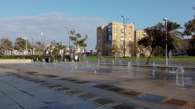 A drone lands in front of a fountain on a street in the city of Be'er Sheva