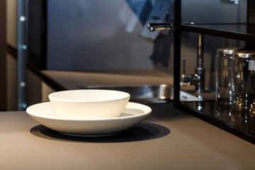 Two bright plates in dark kitchen interior.