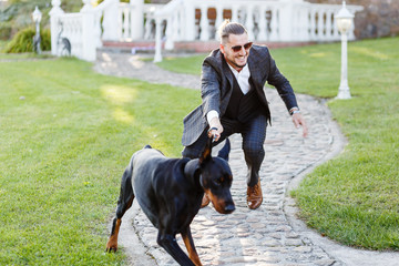 Doberman breaks away from the owner