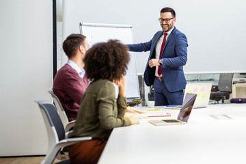 Business colleagues in conference meeting room during presentation
