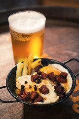 Delicious appetizer of fried eggs with potatoes and sausage