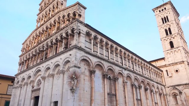 Lucca, Tuscany Italy: Square of the cathedral of San Michele in Foro at sunset, gimbal panning 4K graded from flat, ProRes. Famous for its intact Renaissance-era city walls. Piazza San Michele