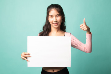 Fototapeta premium Young Asian woman show thumbs up with white blank sign.