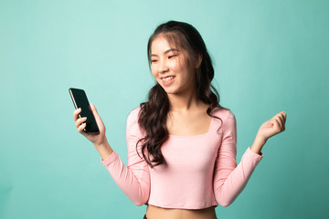 Naklejka premium Happy Young Asian woman with mobile phone.