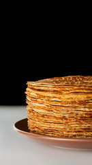 Big stack of delicious pancakes on brown plate National russian cuisine Maslenitsa Blinis Vertical...