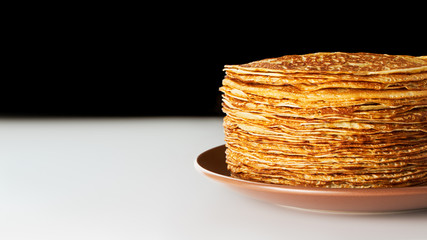 Pancakes on plate Big stack of delicious pancakes on brown plate National russian cuisine Maslenitsa Blinis Horizontal photo with copy free space on left Side view