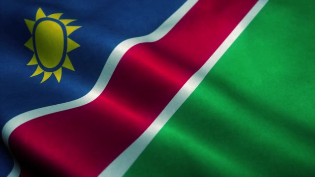 Namibia flag waving in the wind. National flag of Namibia. Sign of Namibia seamless loop animation. 4K