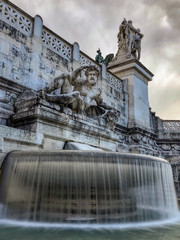 Statue glaring at camera from above a fountain