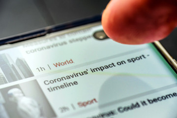 coronavirus impact on sport timeline text on smart phone screen