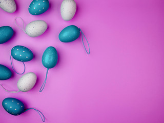 Easter concept. Colored eggs on blue background. Overhead view with copy space.