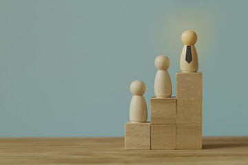 Successful business team leader concept: Businessman standing at the highest point on Wooden block....