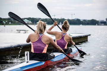 Female kayak athletes in the competition / kayaking water sport