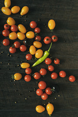 Fototapeta na wymiar Fresh ripe organic cherry tomatoes on dark background