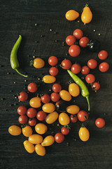 Fresh ripe organic cherry tomatoes on dark background