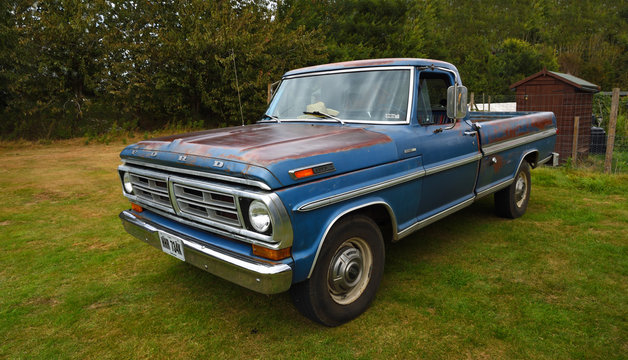  Classic Blue Ford F 250 Pickup parked isolated on park land.