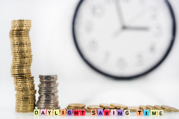 Coins with clock on white table. Summer Daylight Saving Time (DST). Turn time forward (+1h).